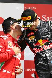 (L to R): Fernando Alonso (ESP) Ferrari with race winner Mark Webber (AUS) Red Bull Racing on the podium. 08.07.2012. Formula 1 World Championship, Rd 9, British Grand Prix, Silverstone, England, Race Day