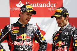 (L to R): Sebastian Vettel (GER) Red Bull Racing with Mark Webber (AUS) Red Bull Racing on the podium. 08.07.2012. Formula 1 World Championship, Rd 9, British Grand Prix, Silverstone, England, Race Day