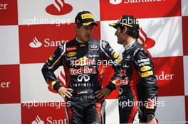 The podium (L to R): Sebastian Vettel (GER) Red Bull Racing with race winner Mark Webber (AUS) Red Bull Racing. 08.07.2012. Formula 1 World Championship, Rd 9, British Grand Prix, Silverstone, England, Race Day