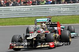 Kimi Raikkonen (FIN) Lotus F1 E20 leads Michael Schumacher (GER) Mercedes AMG F1 W03. 08.07.2012. Formula 1 World Championship, Rd 9, British Grand Prix, Silverstone, England, Race Day