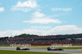 Lewis Hamilton (GBR) McLaren MP4/27 leads Sergio Perez (MEX) Sauber C31. 08.07.2012. Formula 1 World Championship, Rd 9, British Grand Prix, Silverstone, England, Race Day