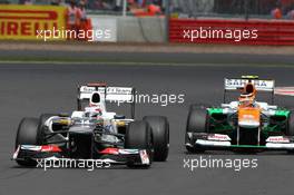 Kamui Kobayashi (JPN) Sauber C31 and Nico Hulkenberg (GER) Sahara Force India F1 VJM05. 08.07.2012. Formula 1 World Championship, Rd 9, British Grand Prix, Silverstone, England, Race Day