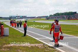 Marshals clear an oil spill on the pit lane entry. 08.07.2012. Formula 1 World Championship, Rd 9, British Grand Prix, Silverstone, England, Race Day