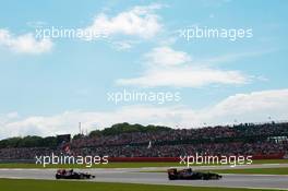 Jean-Eric Vergne (FRA) Scuderia Toro Rosso STR7 leads Daniel Ricciardo (AUS) Scuderia Toro Rosso STR7. 08.07.2012. Formula 1 World Championship, Rd 9, British Grand Prix, Silverstone, England, Race Day