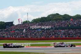 Jean-Eric Vergne (FRA) Scuderia Toro Rosso STR7 leads team mate Daniel Ricciardo (AUS) Scuderia Toro Rosso STR7. 08.07.2012. Formula 1 World Championship, Rd 9, British Grand Prix, Silverstone, England, Race Day