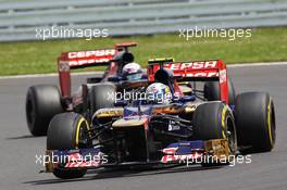 Jean-Eric Vergne (FRA) Scuderia Toro Rosso STR7 leads Daniel Ricciardo (AUS) Scuderia Toro Rosso STR7. 08.07.2012. Formula 1 World Championship, Rd 9, British Grand Prix, Silverstone, England, Race Day