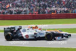Nico Hulkenberg (GER) Sahara Force India F1 VJM05 and Sergio Perez (MEX) Sauber C31 battle for position. 08.07.2012. Formula 1 World Championship, Rd 9, British Grand Prix, Silverstone, England, Race Day