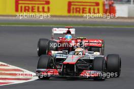 Lewis Hamilton (GBR) McLaren MP4/27 leads Fernando Alonso (ESP) Ferrari F2012. 08.07.2012. Formula 1 World Championship, Rd 9, British Grand Prix, Silverstone, England, Race Day