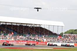 Jean-Eric Vergne (FRA) Scuderia Toro Rosso STR7; Nico Rosberg (GER) Mercedes AMG F1 W03 and Daniel Ricciardo (AUS) Scuderia Toro Rosso STR7 battle for position. 08.07.2012. Formula 1 World Championship, Rd 9, British Grand Prix, Silverstone, England, Race Day