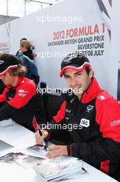 Timo Glock (GER) Marussia F1 Team signs autographs for the fans. 07.07.2012. Formula 1 World Championship, Rd 9, British Grand Prix, Silverstone, England, Qualifying Day