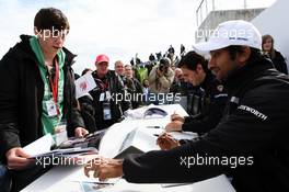 Narain Karthikeyan (IND) Hispania Racing F1 Team (HRT) signs autographs for the fans. 07.07.2012. Formula 1 World Championship, Rd 9, British Grand Prix, Silverstone, England, Qualifying Day