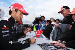 Jenson Button (GBR) McLaren signs autographs for the fans. 07.07.2012. Formula 1 World Championship, Rd 9, British Grand Prix, Silverstone, England, Qualifying Day