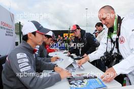 Kamui Kobayashi (JPN) Sauber signs autographs for the fans. 07.07.2012. Formula 1 World Championship, Rd 9, British Grand Prix, Silverstone, England, Qualifying Day