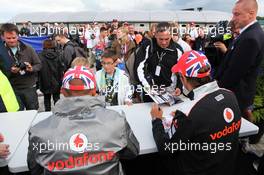 Lewis Hamilton (GBR) McLaren and Jenson Button (GBR) McLaren sign autographs for the fans. 07.07.2012. Formula 1 World Championship, Rd 9, British Grand Prix, Silverstone, England, Qualifying Day