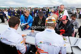 Paul di Resta (GBR) Sahara Force India F1 and Nico Hulkenberg (GER) Sahara Force India F1 sign autographs for the fans. 07.07.2012. Formula 1 World Championship, Rd 9, British Grand Prix, Silverstone, England, Qualifying Day