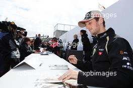 Romain Grosjean (FRA) Lotus F1 Team signs autographs for the fans. 07.07.2012. Formula 1 World Championship, Rd 9, British Grand Prix, Silverstone, England, Qualifying Day