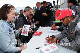 Lewis Hamilton (GBR) McLaren and Jenson Button (GBR) McLaren sign autographs for the fans. 07.07.2012. Formula 1 World Championship, Rd 9, British Grand Prix, Silverstone, England, Qualifying Day