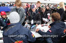 Daniel Ricciardo (AUS) Scuderia Toro Rosso and Jean-Eric Vergne (FRA) Scuderia Toro Rosso sign autographs for the fans. 07.07.2012. Formula 1 World Championship, Rd 9, British Grand Prix, Silverstone, England, Qualifying Day
