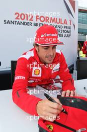Fernando Alonso (ESP) Ferrari signs autographs for the fans. 07.07.2012. Formula 1 World Championship, Rd 9, British Grand Prix, Silverstone, England, Qualifying Day