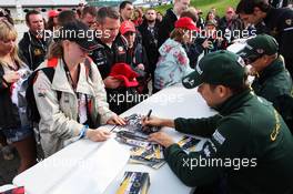 Heikki Kovalainen (FIN) Caterham and Vitaly Petrov (RUS) Caterham sign autographs for the fans. 07.07.2012. Formula 1 World Championship, Rd 9, British Grand Prix, Silverstone, England, Qualifying Day