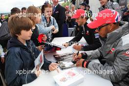 Lewis Hamilton (GBR) McLaren and Jenson Button (GBR) McLaren sign autographs for the fans. 07.07.2012. Formula 1 World Championship, Rd 9, British Grand Prix, Silverstone, England, Qualifying Day