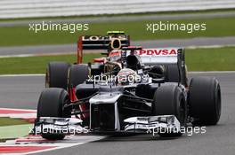 Pastor Maldonado (VEN) Williams FW34 leads Romain Grosjean (FRA) Lotus F1 E20. 07.07.2012. Formula 1 World Championship, Rd 9, British Grand Prix, Silverstone, England, Qualifying Day