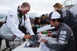 Sergio Perez (MEX) Sauber signs autographs for the fans. 07.07.2012. Formula 1 World Championship, Rd 9, British Grand Prix, Silverstone, England, Qualifying Day