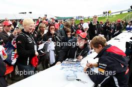 Sebastian Vettel (GER) Red Bull Racing signs autographs for the fans. 07.07.2012. Formula 1 World Championship, Rd 9, British Grand Prix, Silverstone, England, Qualifying Day