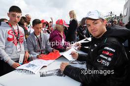 Nico Rosberg (GER) Mercedes AMG F1 signs autographs for the fans. 07.07.2012. Formula 1 World Championship, Rd 9, British Grand Prix, Silverstone, England, Qualifying Day