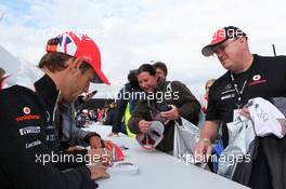 Jenson Button (GBR) McLaren signs autographs for the fans. 07.07.2012. Formula 1 World Championship, Rd 9, British Grand Prix, Silverstone, England, Qualifying Day