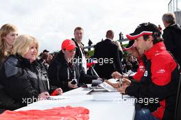Timo Glock (GER) Marussia F1 Team and Charles Pic (FRA) Marussia F1 Team sign autographs for the fans. 07.07.2012. Formula 1 World Championship, Rd 9, British Grand Prix, Silverstone, England, Qualifying Day
