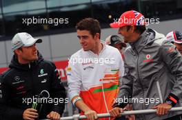 (L to R): Nico Rosberg (GER) Mercedes AMG F1 with Paul di Resta (GBR) Sahara Force India F1 and Jenson Button (GBR) McLaren on the drivers parade. 08.07.2012. Formula 1 World Championship, Rd 9, British Grand Prix, Silverstone, England, Race Day
