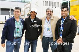Narain Karthikeyan (IND) Hispania Racing F1 Team (HRT) with Vicky Chandhok (IND) and Karun Chandhok (IND). 08.07.2012. Formula 1 World Championship, Rd 9, British Grand Prix, Silverstone, England, Race Day
