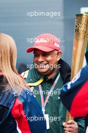 Tony Fernandes (MAL) Caterham Team Principal with the Olympic Torch. 08.07.2012. Formula 1 World Championship, Rd 9, British Grand Prix, Silverstone, England, Race Day