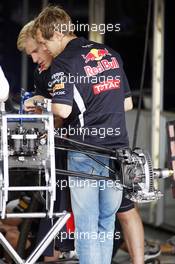 Sebastian Vettel (GER) Red Bull Racing looks at his Red Bull Racing RB8. 05.07.2012. Formula 1 World Championship, Rd 9, British Grand Prix, Silverstone, England, Preparation Day