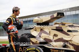 Romain Grosjean (FRA) Lotus F1 E20 with the Tumbler vehicle from the Batman movie The Dark Night Rises. 05.07.2012. Formula 1 World Championship, Rd 9, British Grand Prix, Silverstone, England, Preparation Day