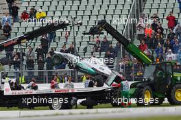 Michael Schumacher (GER) watches as his Mercedes AMG F1 W03 is craned away after he crashed in the second practice session. 20.07.2012. Formula 1 World Championship, Rd 10, German Grand Prix, Hockenheim, Germany, Practice Day