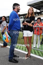 Dasha Kapustina (RUS), girlfriend of Fernando Alonso (ESP) Ferrari with Luis Garcia Abad (ESP), manager of Alonso. 20.07.2012. Formula 1 World Championship, Rd 10, German Grand Prix, Hockenheim, Germany, Practice Day