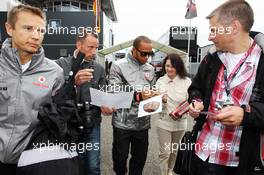 Lewis Hamilton (GBR) McLaren signs autographs for the fans. 20.07.2012. Formula 1 World Championship, Rd 10, German Grand Prix, Hockenheim, Germany, Practice Day