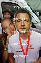 McLaren fans with cut out faces of Lewis Hamilton (GBR) McLaren and John Terry (GBR) Football Player 22.07.2012. Formula 1 World Championship, Rd 10, German Grand Prix, Hockenheim, Germany, Race Day