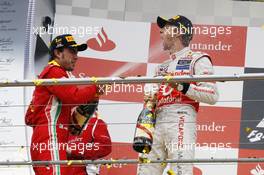 (L to R): Race winner Fernando Alonso (ESP) Ferrari celebrates on the podium with Jenson Button (GBR) McLaren. 22.07.2012. Formula 1 World Championship, Rd 10, German Grand Prix, Hockenheim, Germany, Race Day