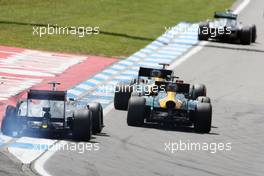 Lewis Hamilton (GBR) McLaren MP4/27 suffers a puncture as Heikki Kovalainen (FIN) Caterham CT01 and team mate Vitaly Petrov (RUS) Caterham CT01 battle for position. 22.07.2012. Formula 1 World Championship, Rd 10, German Grand Prix, Hockenheim, Germany, Race Day