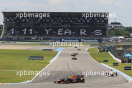 Mark Webber (AUS), Red Bull Racing ahead of the Mercedes-Benz grandstand where fans show 111 years of Mercedes-Benz 22.07.2012. Formula 1 World Championship, Rd 10, German Grand Prix, Hockenheim, Germany, Race Day