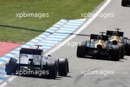 Lewis Hamilton (GBR) McLaren MP4/27 suffers a puncture as Heikki Kovalainen (FIN) Caterham CT01 and team mate Vitaly Petrov (RUS) Caterham CT01 battle for position. 22.07.2012. Formula 1 World Championship, Rd 10, German Grand Prix, Hockenheim, Germany, Race Day