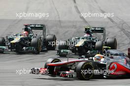 Lewis Hamilton (GBR) McLaren MP4/27 suffers a puncture as Heikki Kovalainen (FIN) Caterham CT01 and team mate Vitaly Petrov (RUS) Caterham CT01 battle for position. 22.07.2012. Formula 1 World Championship, Rd 10, German Grand Prix, Hockenheim, Germany, Race Day