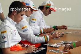 (L to R): Paul di Resta (GBR) Sahara Force India F1; Nico Hulkenberg (GER) Sahara Force India F1 and Jules Bianchi (FRA) Sahara Force India F1 Team Third Driver sign autographs for the fans. 21.07.2012. Formula 1 World Championship, Rd 10, German Grand Prix, Hockenheim, Germany, Qualifying Day