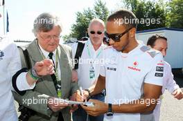 Lewis Hamilton (GBR) McLaren signs autographs for the fans. 22.07.2012. Formula 1 World Championship, Rd 10, German Grand Prix, Hockenheim, Germany, Race Day