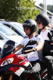 Jenson Button (GBR) McLaren arrrives at the circuit on a motorbike with Mike Collier (GBR) Personal Trainer. 22.07.2012. Formula 1 World Championship, Rd 10, German Grand Prix, Hockenheim, Germany, Race Day