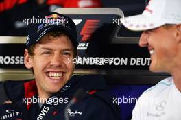 (L to R): Sebastian Vettel (GER) Red Bull Racing with Michael Schumacher (GER) Mercedes AMG F1 in the FIA Press Conference. 19.07.2012. Formula 1 World Championship, Rd 10, German Grand Prix, Hockenheim, Germany, Preparation Day