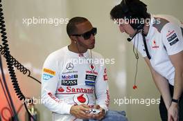 Lewis Hamilton (GBR) McLaren MP4/27 on his mobile phone in the pits. 27.07.2012. Formula 1 World Championship, Rd 11, Hungarian Grand Prix, Budapest, Hungary, Practice Day